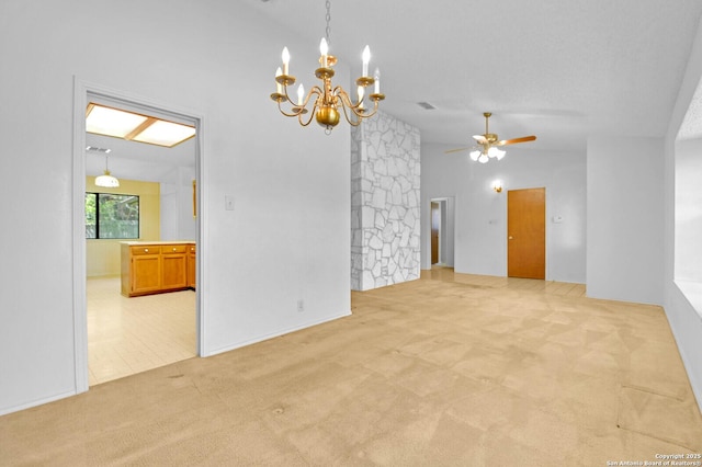 empty room featuring ceiling fan with notable chandelier, vaulted ceiling, and light carpet