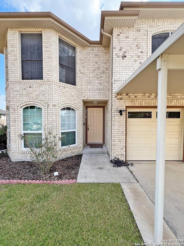 7514 Autumn Ledge, Converse, TX 78109 - view of front facade featuring brick siding, a front yard, concrete driveway, and an attached garage