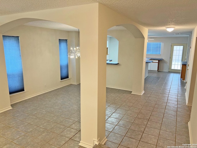 7514 Autumn Ledge, Converse, TX 78109 - tiled spare room with baseboards and a textured ceiling