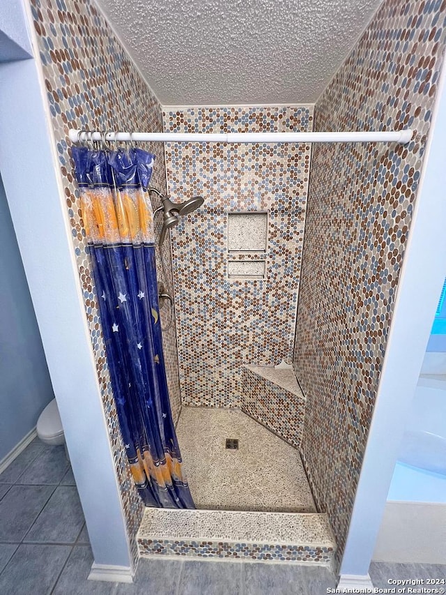7514 Autumn Ledge, Converse, TX 78109 - full bath featuring tile patterned floors, baseboards, a stall shower, and toilet