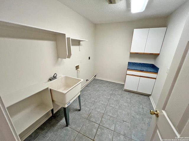 7514 Autumn Ledge, Converse, TX 78109 - clothes washing area with hookup for a washing machine, hookup for an electric dryer, baseboards, a textured ceiling, and light tile patterned flooring