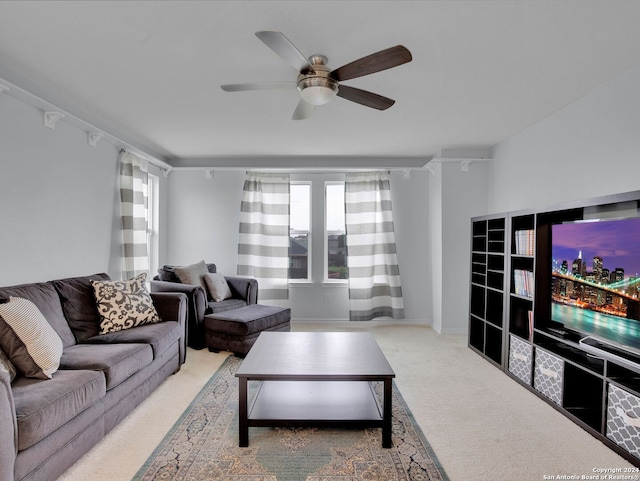 living area with carpet and a ceiling fan