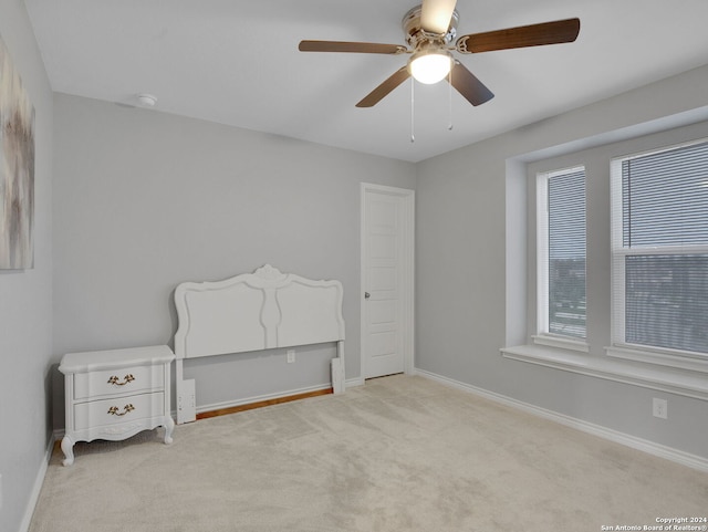 unfurnished bedroom featuring ceiling fan, carpet floors, and baseboards