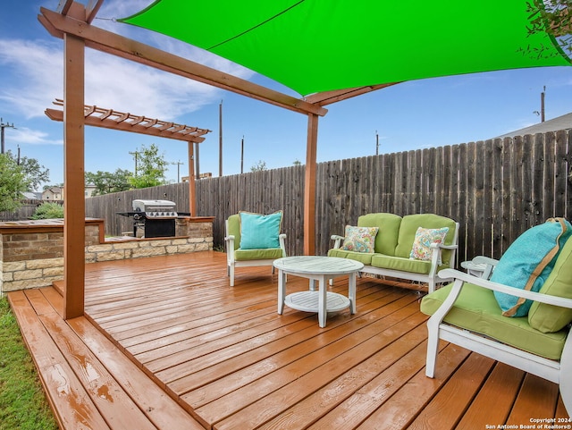 deck with grilling area, area for grilling, an outdoor living space, and a fenced backyard