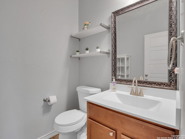 half bath featuring toilet and vanity