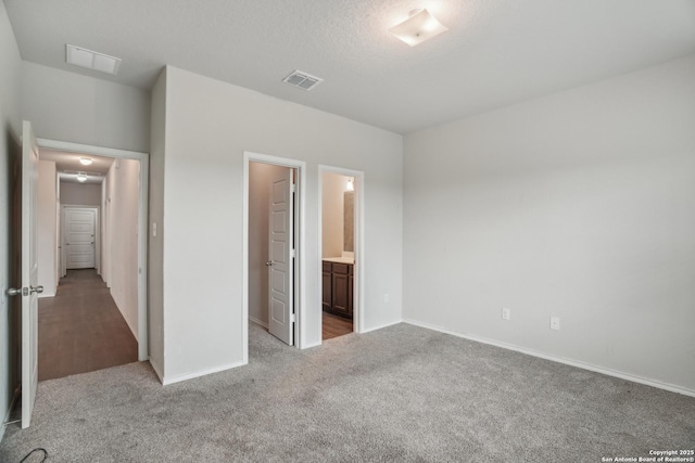 unfurnished bedroom featuring baseboards, visible vents, and carpet floors