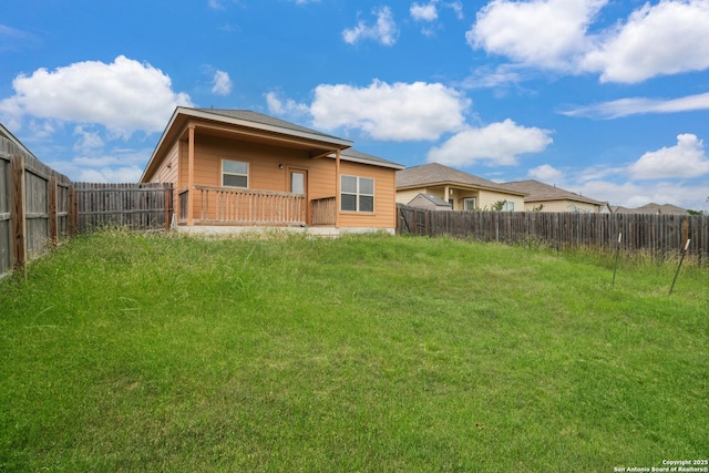 rear view of property with a fenced backyard