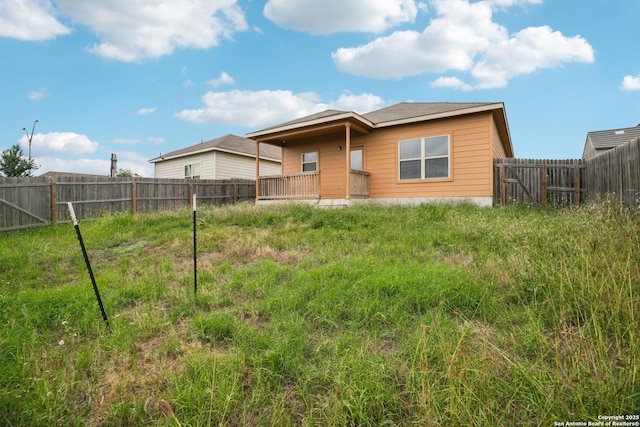 back of property with a fenced backyard