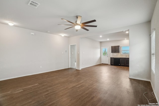 unfurnished living room featuring visible vents, ceiling fan, baseboards, and dark wood-type flooring