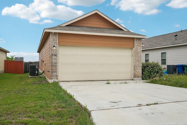 garage with concrete driveway, central AC, and fence