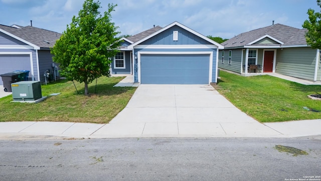 ranch-style house with driveway, board and batten siding, a front yard, and an attached garage