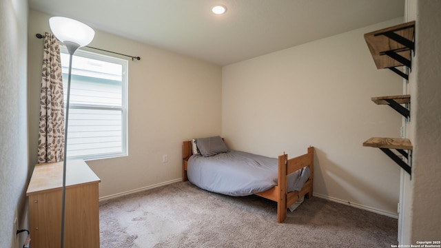 bedroom featuring carpet flooring and baseboards