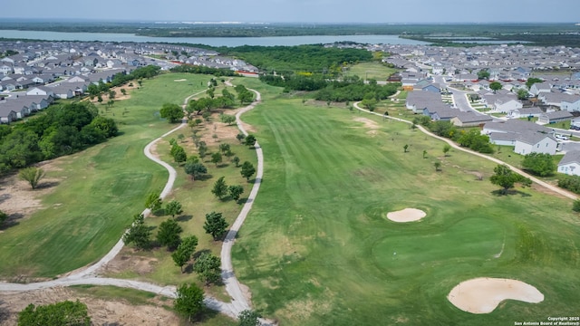 aerial view with a residential view, a water view, and view of golf course