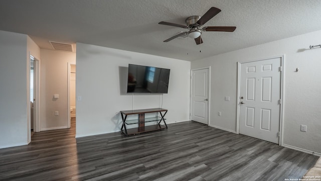 unfurnished living room with a ceiling fan, visible vents, dark wood-style flooring, and a textured ceiling