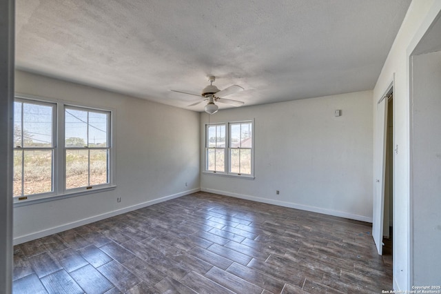 unfurnished room with baseboards, a ceiling fan, a textured ceiling, and dark wood-style flooring