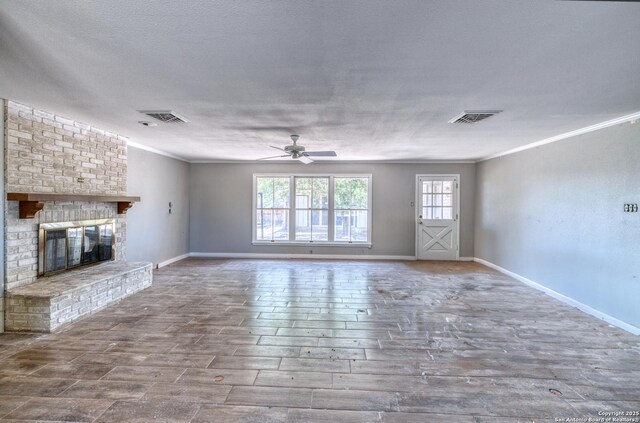 unfurnished living room featuring visible vents, ceiling fan, ornamental molding, and baseboards