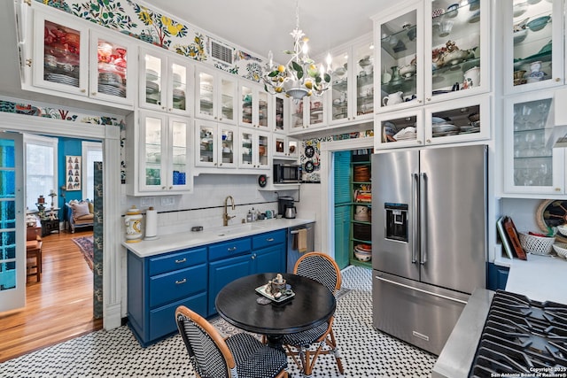 112 King William, San Antonio, TX 78204 - kitchen with blue cabinetry, stainless steel appliances, and white cabinets
