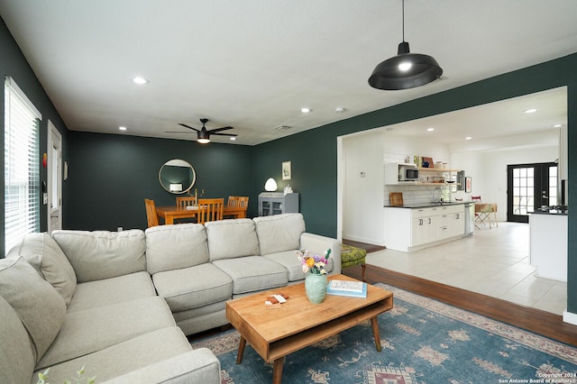 living area with visible vents, light wood-type flooring, a ceiling fan, and recessed lighting