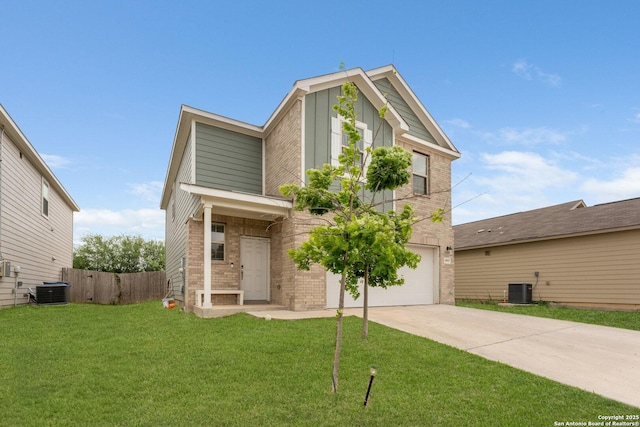 traditional-style house featuring concrete driveway, board and batten siding, a front yard, fence, and brick siding