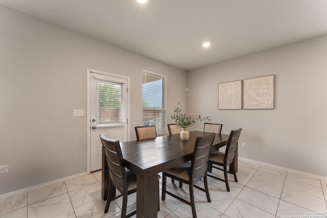 dining space with recessed lighting, marble finish floor, and baseboards
