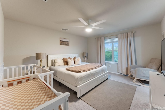 carpeted bedroom featuring visible vents and ceiling fan