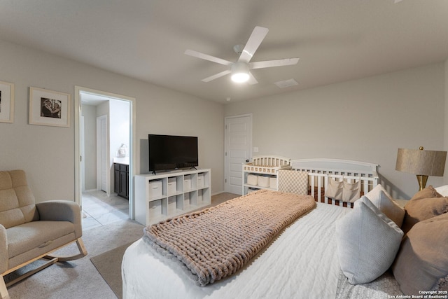 bedroom with a ceiling fan, visible vents, and light carpet