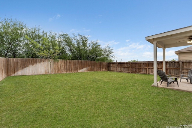 view of yard featuring ceiling fan, a fenced backyard, and a patio area