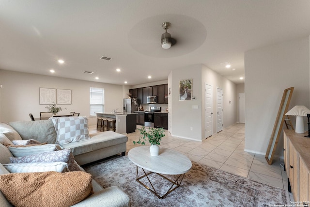 living room with ceiling fan, visible vents, baseboards, recessed lighting, and marble finish floor