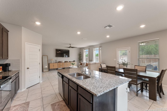 kitchen with visible vents, stainless steel dishwasher, marble finish floor, and a sink