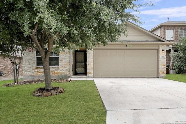 view of front of home featuring stone siding, a front yard, concrete driveway, and an attached garage