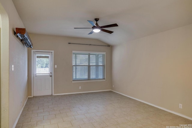 spare room featuring baseboards, light tile patterned floors, a ceiling fan, and lofted ceiling