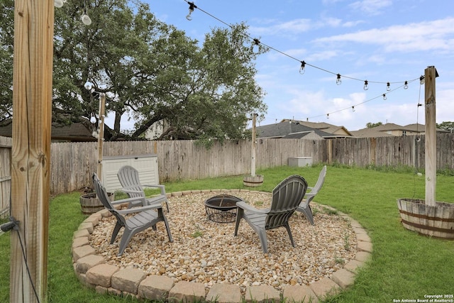 view of yard with an outdoor fire pit and a fenced backyard