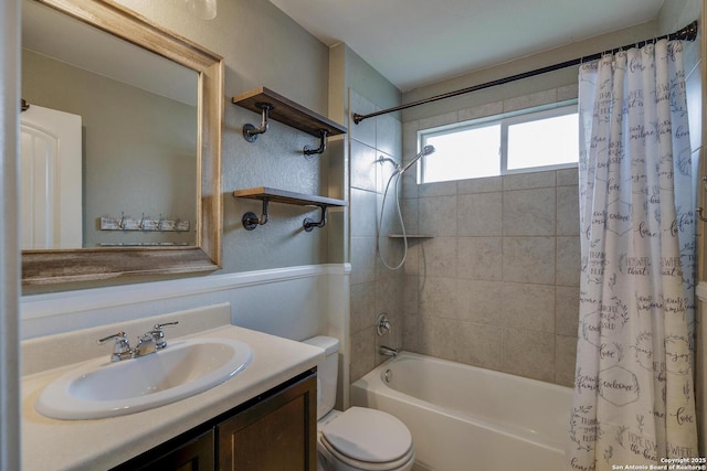 full bathroom featuring shower / bath combination with curtain, toilet, and vanity