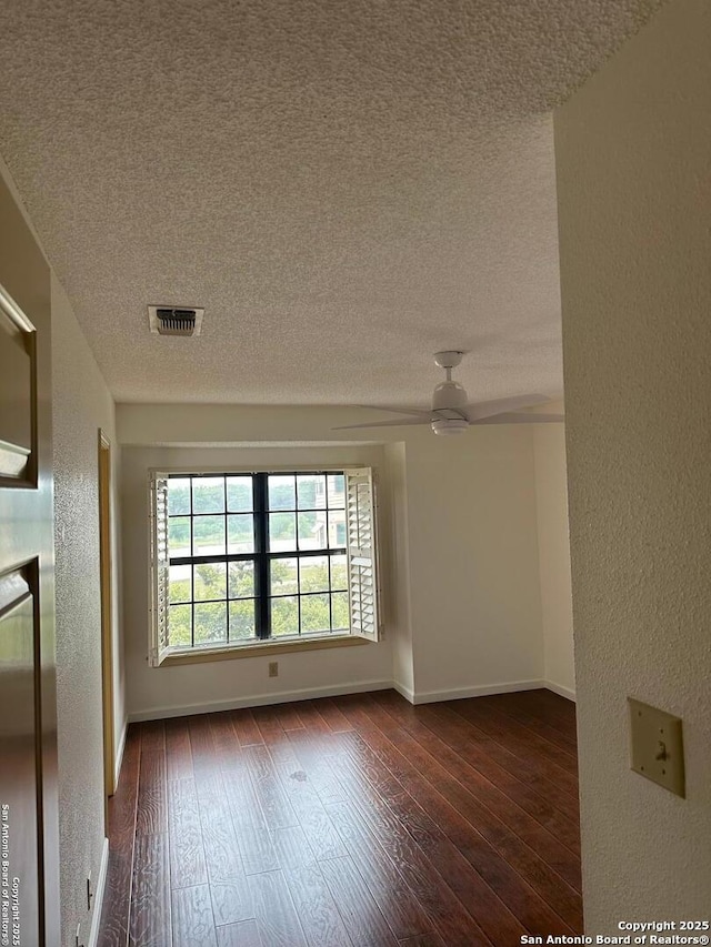 10955 Wurzbach Unit 203, San Antonio, TX 78230 - empty room with dark wood-style floors, visible vents, ceiling fan, and a textured ceiling