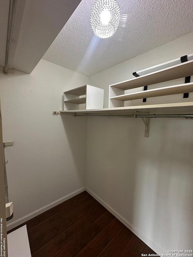10955 Wurzbach Unit 203, San Antonio, TX 78230 - walk in closet with dark wood-type flooring