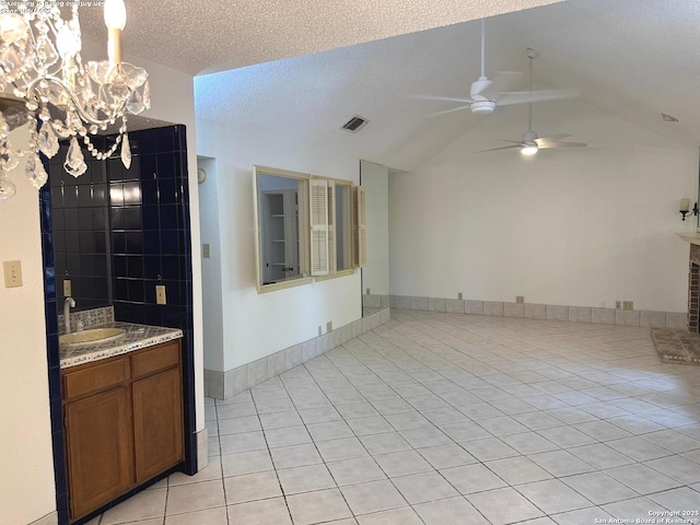 10955 Wurzbach Unit 203, San Antonio, TX 78230 - interior space with a sink, light tile patterned floors, visible vents, vaulted ceiling, and ceiling fan with notable chandelier