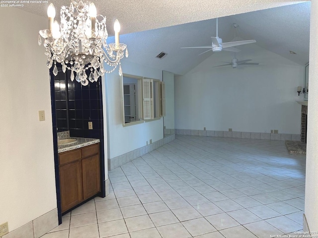 10955 Wurzbach Unit 203, San Antonio, TX 78230 - unfurnished dining area featuring vaulted ceiling, ceiling fan with notable chandelier, visible vents, a textured ceiling, and light tile patterned flooring