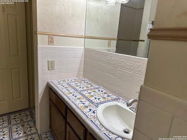 10955 Wurzbach Unit 203, San Antonio, TX 78230 - bathroom featuring tile walls, tile patterned flooring, and vanity