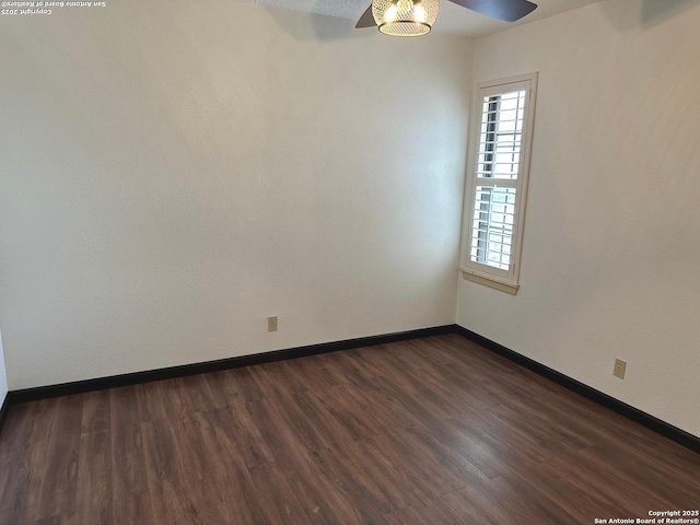 10955 Wurzbach Unit 203, San Antonio, TX 78230 - empty room with ceiling fan, dark wood finished floors, and baseboards