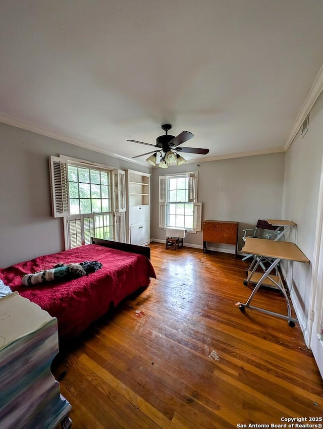 2465 Gladys St, Beaumont, TX 77702 - bedroom featuring wood finished floors, ceiling fan, crown molding, and baseboards