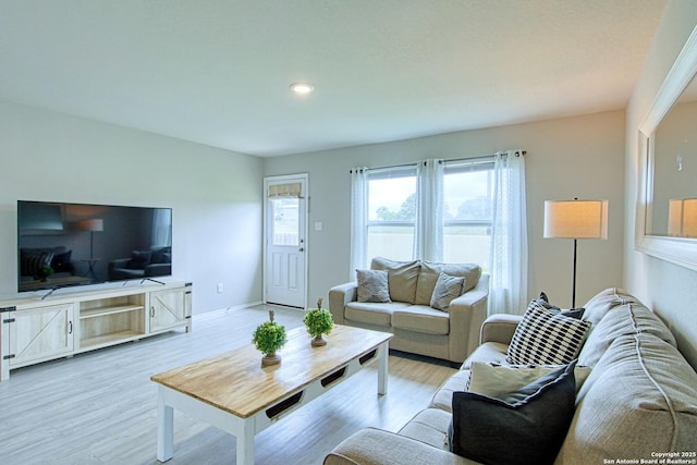 living area featuring recessed lighting, light wood-style flooring, and baseboards