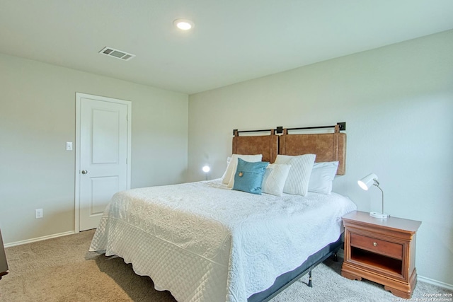 bedroom with carpet floors, visible vents, and baseboards