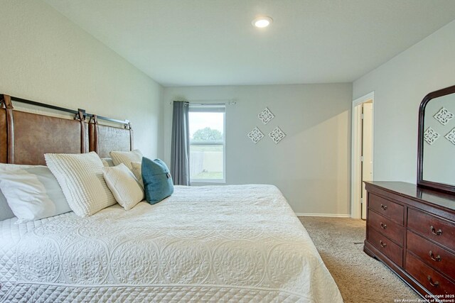 bedroom with recessed lighting and light carpet