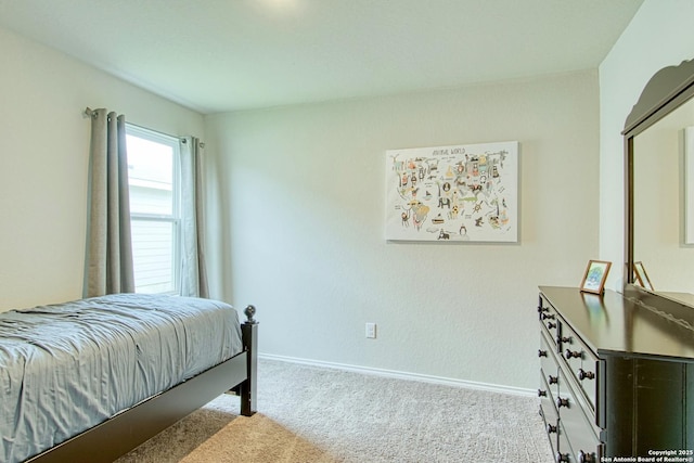 bedroom featuring carpet flooring and baseboards
