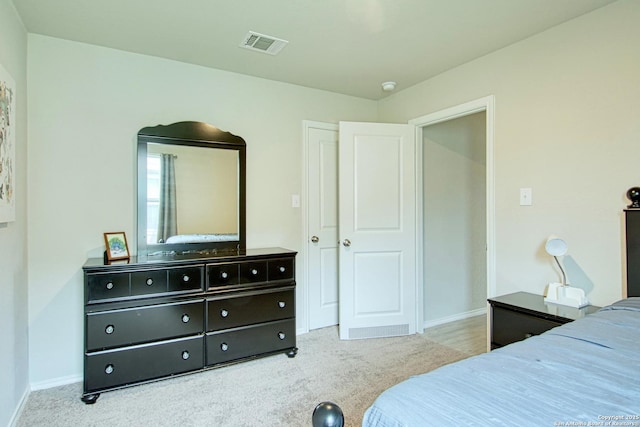 bedroom with visible vents, carpet, and baseboards