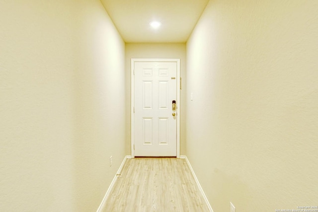 interior space with light wood finished floors and baseboards
