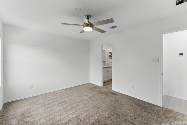 unfurnished room featuring ceiling fan, baseboards, light carpet, and visible vents
