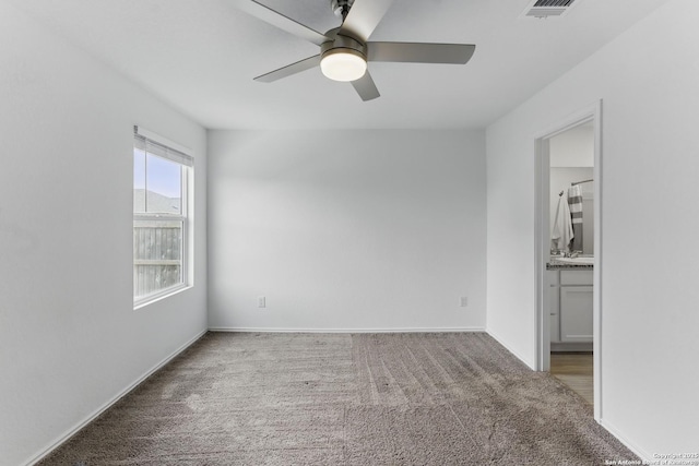 unfurnished bedroom featuring visible vents, ceiling fan, carpet, and baseboards