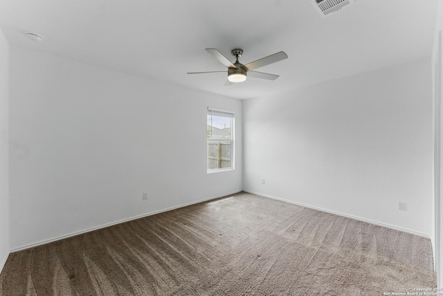 spare room with baseboards, visible vents, ceiling fan, and carpet flooring