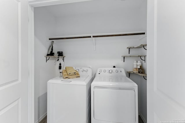 washroom with washing machine and clothes dryer and laundry area